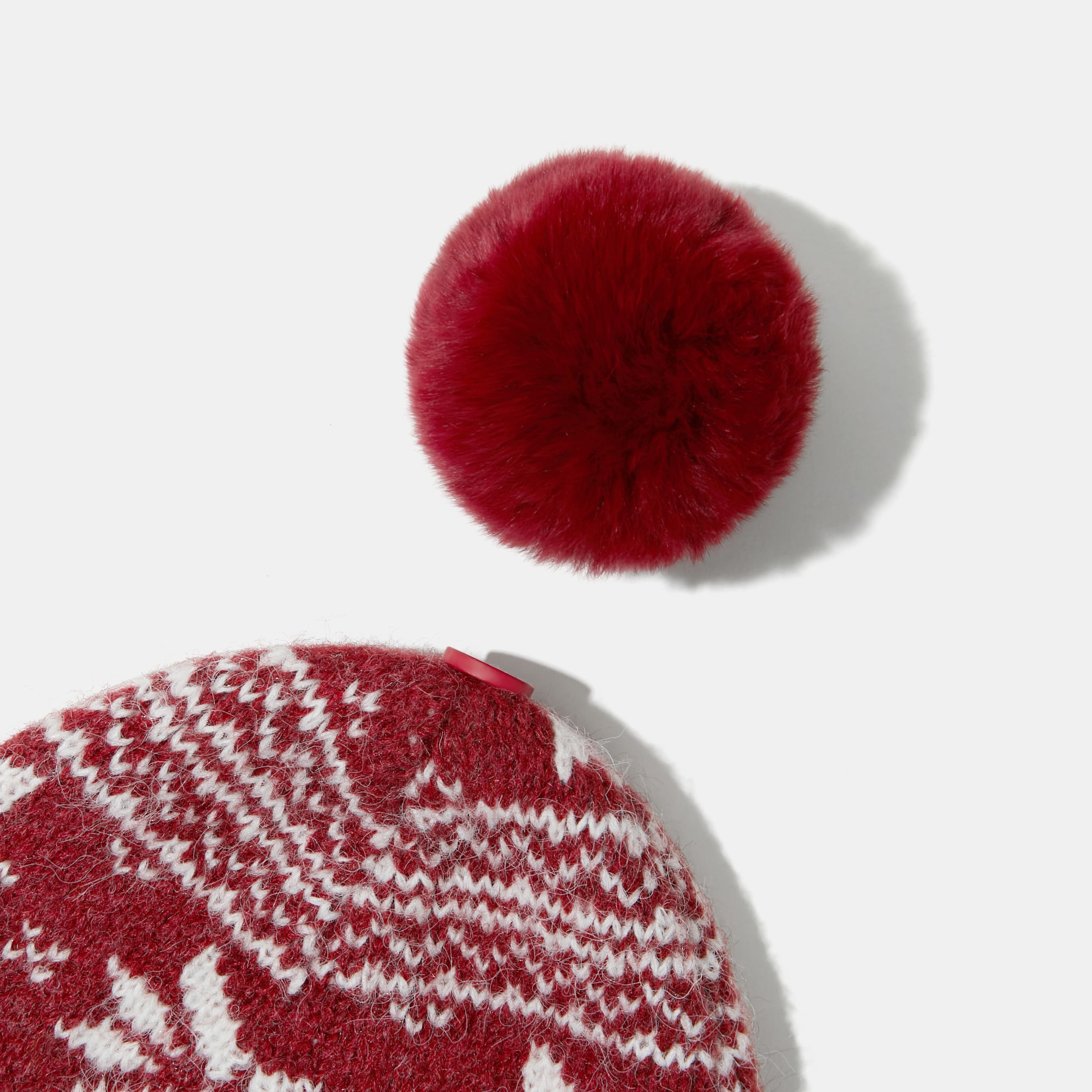 Knitted hat with removable pom pom