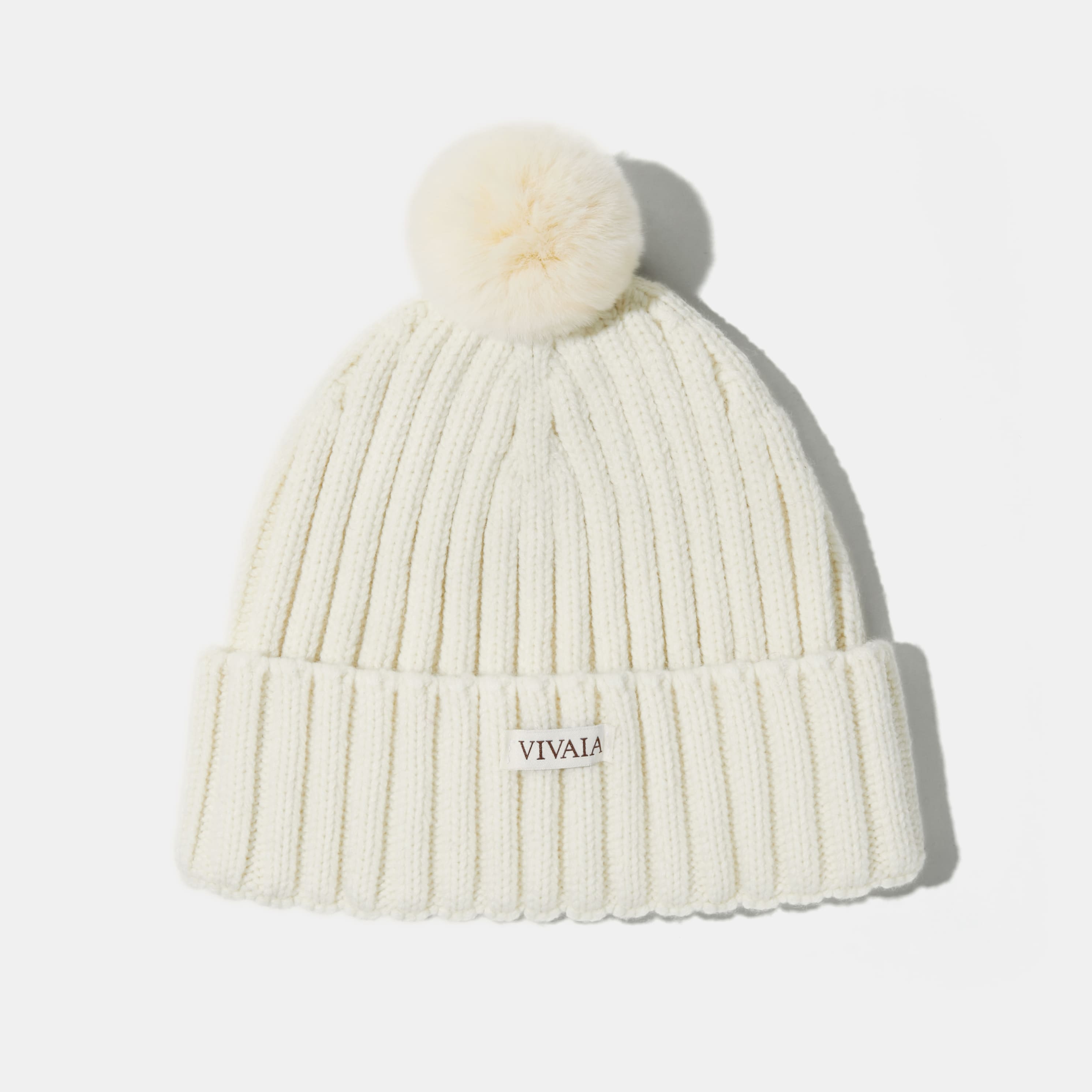 Knitted hat with removable pom pom