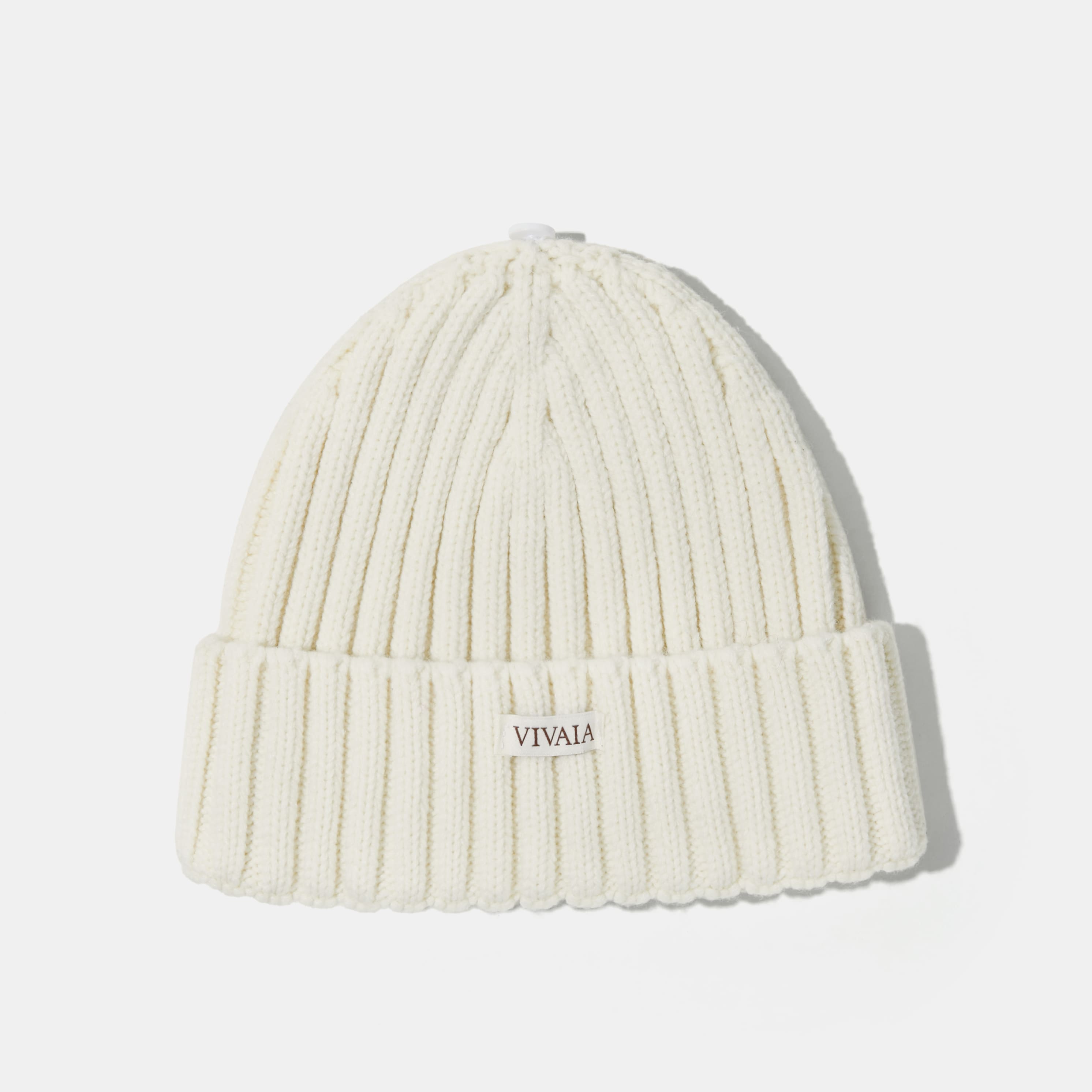 Knitted hat with removable pom pom