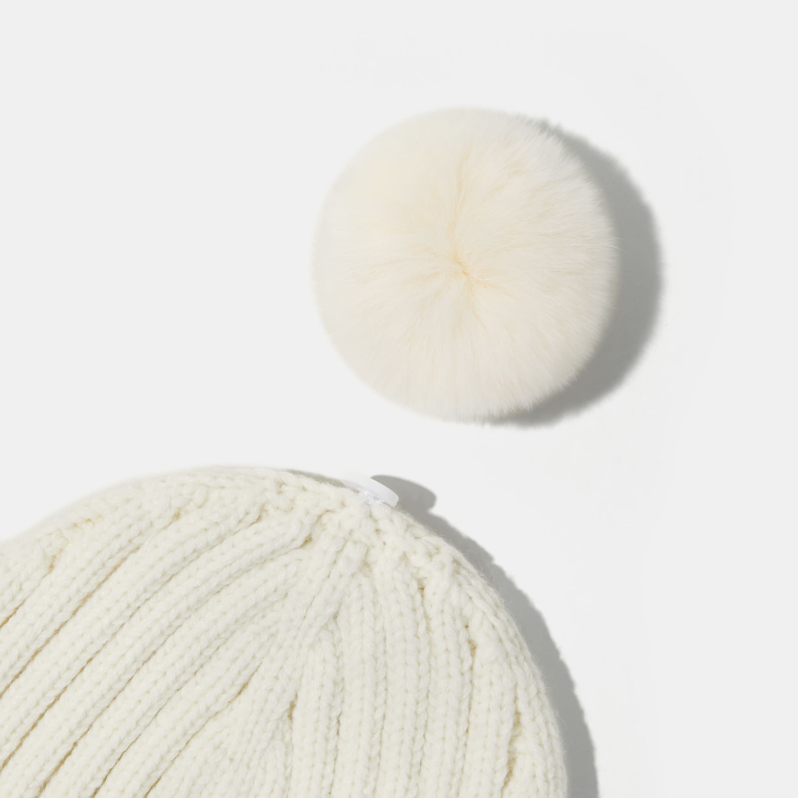 Knitted hat with removable pom pom